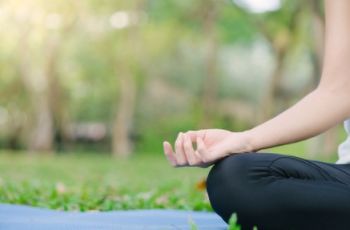 person sitting in a yoga pose outside